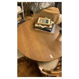 Round wooden table with two leaves and three