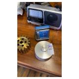 Lot of Bulova clock, radio, gear, and metal