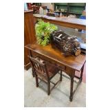 Lot of wooden desk and chair, glass pig jar, and