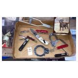 Tray of pocket knives handcuffs retriever tin