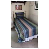 Single brass bed with bedding