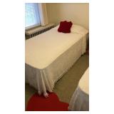 Pair of twin beds, pillows, heart rug