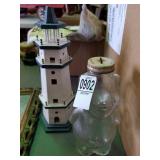 Glass piggy bank and wooden lighthouse