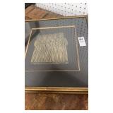 Picture with monks in black and gold framed by