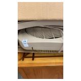 Tan standing fan in box