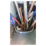 Garbage can full of sledge hammers and outdoor