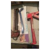 Caulk guns and claw bar