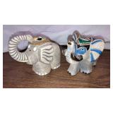 2 elephant figurines 1 made in Uruguay  4" long
