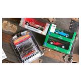 4 die cast  car models in boxes