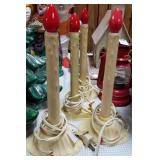 4 single lighted window candles