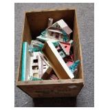 Wooden box full of paper Christmas houses