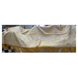 Yellow patterned coverlet with fringe