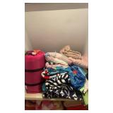 Shelf lot of beach towels , sleeping bag etc