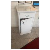 White metal cabinet with contents