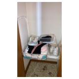 Clothing shoes in storage tubs closet contents