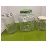 Three-piece glass storage jars- largest is 8.5