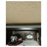 Shelf lot of hats, glassware