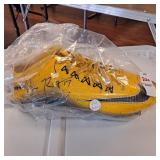 Autographed yellow Nike football cleat, Eli