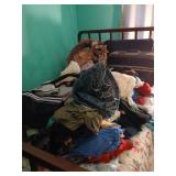 All items on bed, clothes, afghan, luggage etc