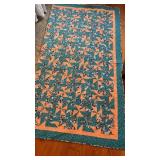Handmade quilt featuring a teal and peach design