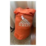 Kelty orange gear bag with sleeping bag inside