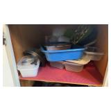 Shelf of Tupperware and other kitchen pans
