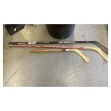 3 wooden hockey sticks
