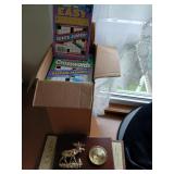 Box of new crossword puzzle books and thermometer