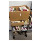 Metal mobile book cart with books