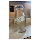 Vintage embossed glass dairy bottle from Fikes