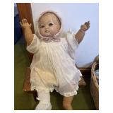 Vintage composition baby doll on stool