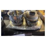 Stainless steel cookware set with serving plate