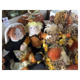 Faux floral cornucopia, stuffed pilgrims and wall