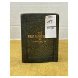 Vintage leather-bound book-shaped coin bank from