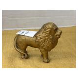 Vintage gold-toned cast iron lion still coin bank
