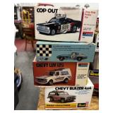 4 boxes of model cars and pieces