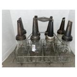 Vintage wire bottle carrier holding 8 clear glass