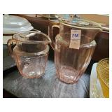 2 pink depression glass pitchers