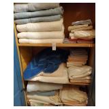 4 shelves of towels, candles and Christmas basket