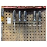 Lot of screwdrivers in wall mounts