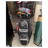 Nike golf bag with assorted golf clubs -