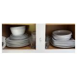 Shelf lot of white dishes and glass cups