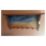 Wall mounted wooden shelf and peg rack with a