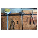 Wall lot - 3 Brooms, 2 handsaws, hoe, and Corona