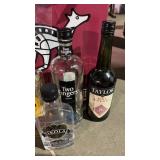 Lot of opened liquor and 2 new bottles of wine