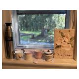 Stainless steel bottle, teacups and welcome sign