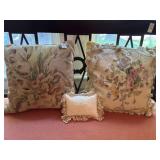 2 floral throw pillows and sleeping baby hanging