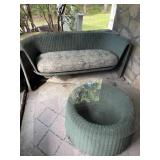 Green wicker bench with cushion and table with