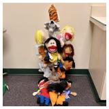 A Collection of Plush Hand Puppets and a Tiered Wo