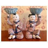 A pair of famille rose millefleur seated children